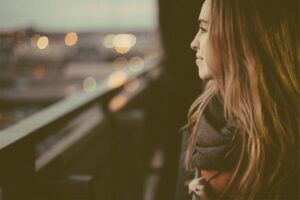 Woman smiling as she looks out on the city.